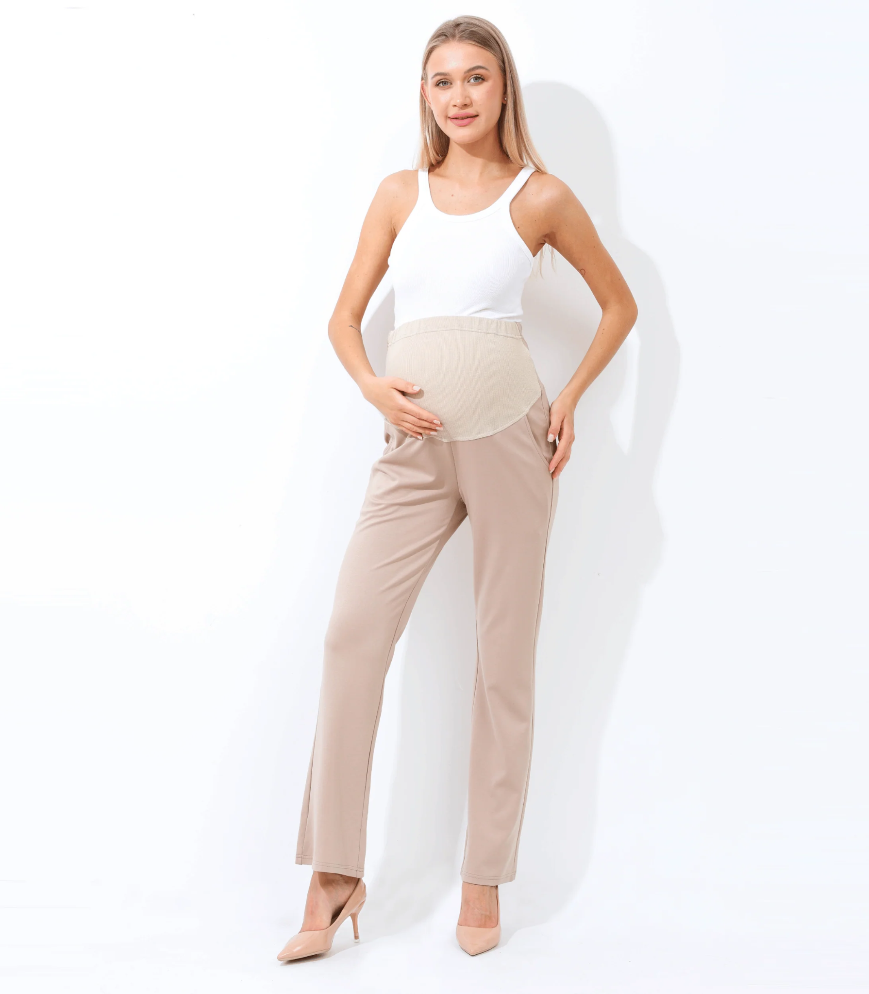 Pregnant woman wearing beige maternity pants.